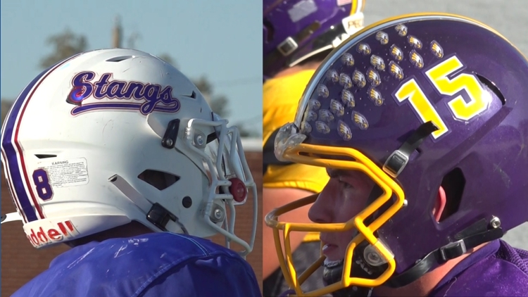 Two young football players with one arm each showcasing determination on the field.